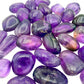 Overhead flat-lay of Bolivian Ametrine tumbled stones, 24 to 40 pieces a pound