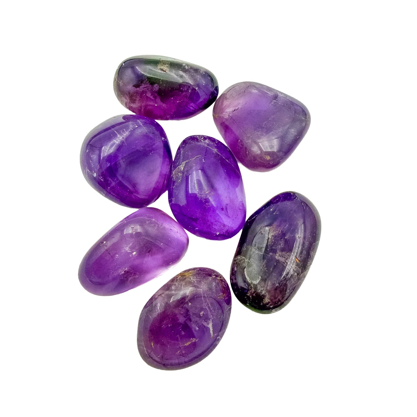 Ametrine tumbles arranged to show how the two-color split varies piece to piece