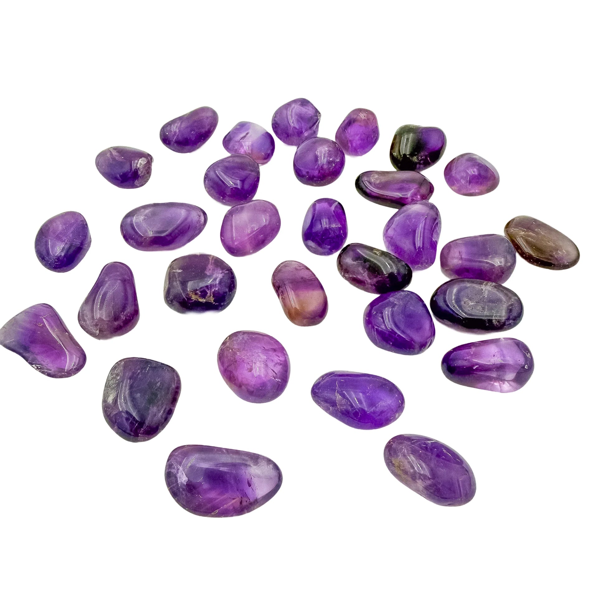 Loose Ametrine tumbles with light passing through the citrine zones