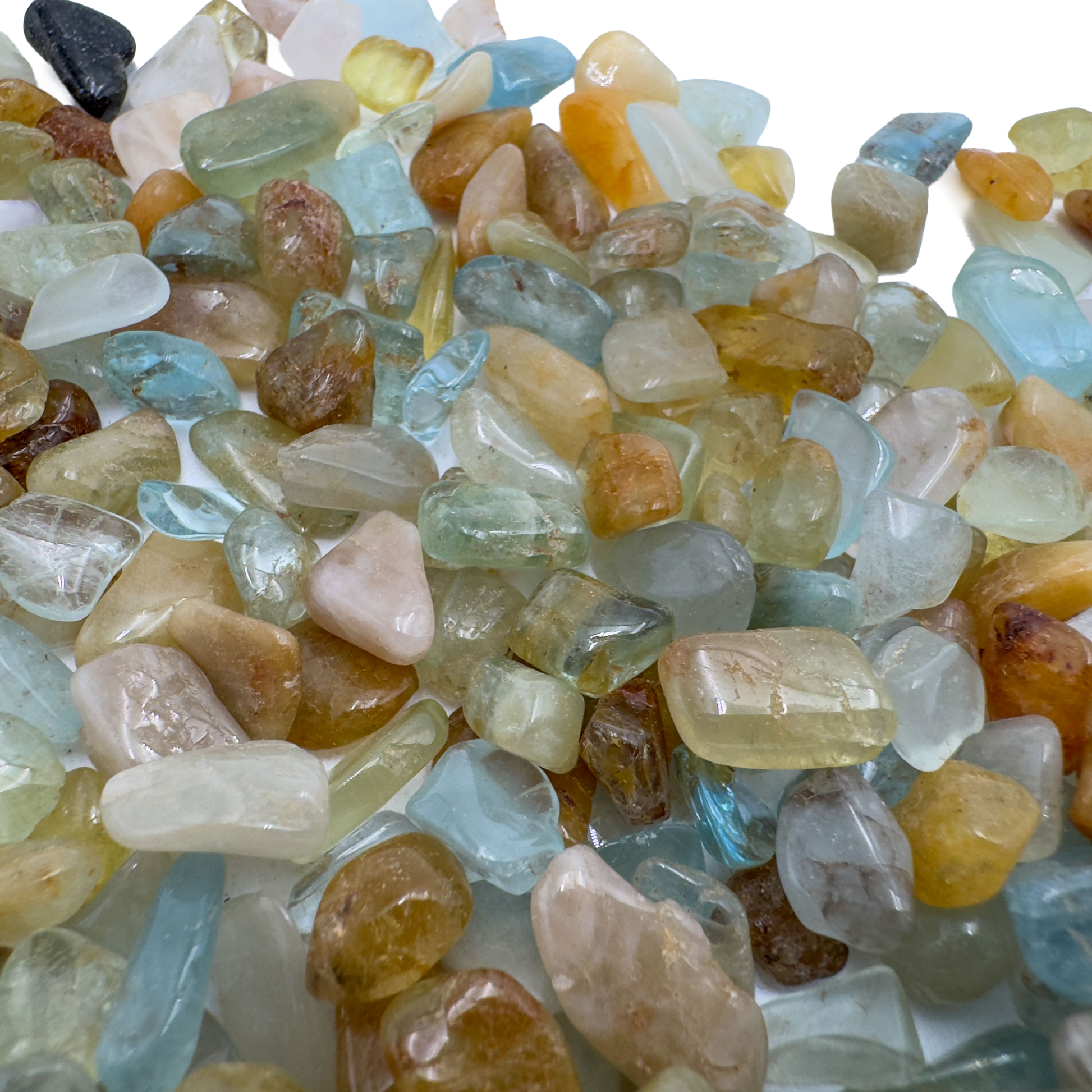 Holding an Aquamarine stone, from Huila, Angola, shown in a calm studio setting.