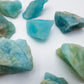 Reverse side of blue Aquamarine raw stone, drawn on for Stress Relief and Emotional Healing, showing natural form.