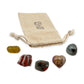 Aries Crystal Kit: natural citrine, red jasper, bloodstone, ocean jasper heart and hematite, arranged with the reusable cotton bag they come in, on white