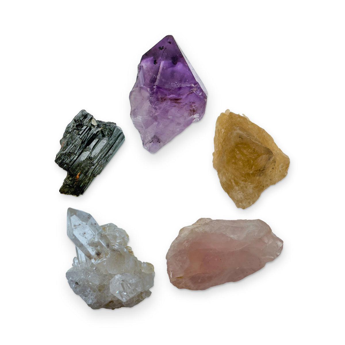 The Beginner's First Five Kit: amethyst point, natural citrine, rose quartz, clear quartz cluster and black tourmaline, shown together on white