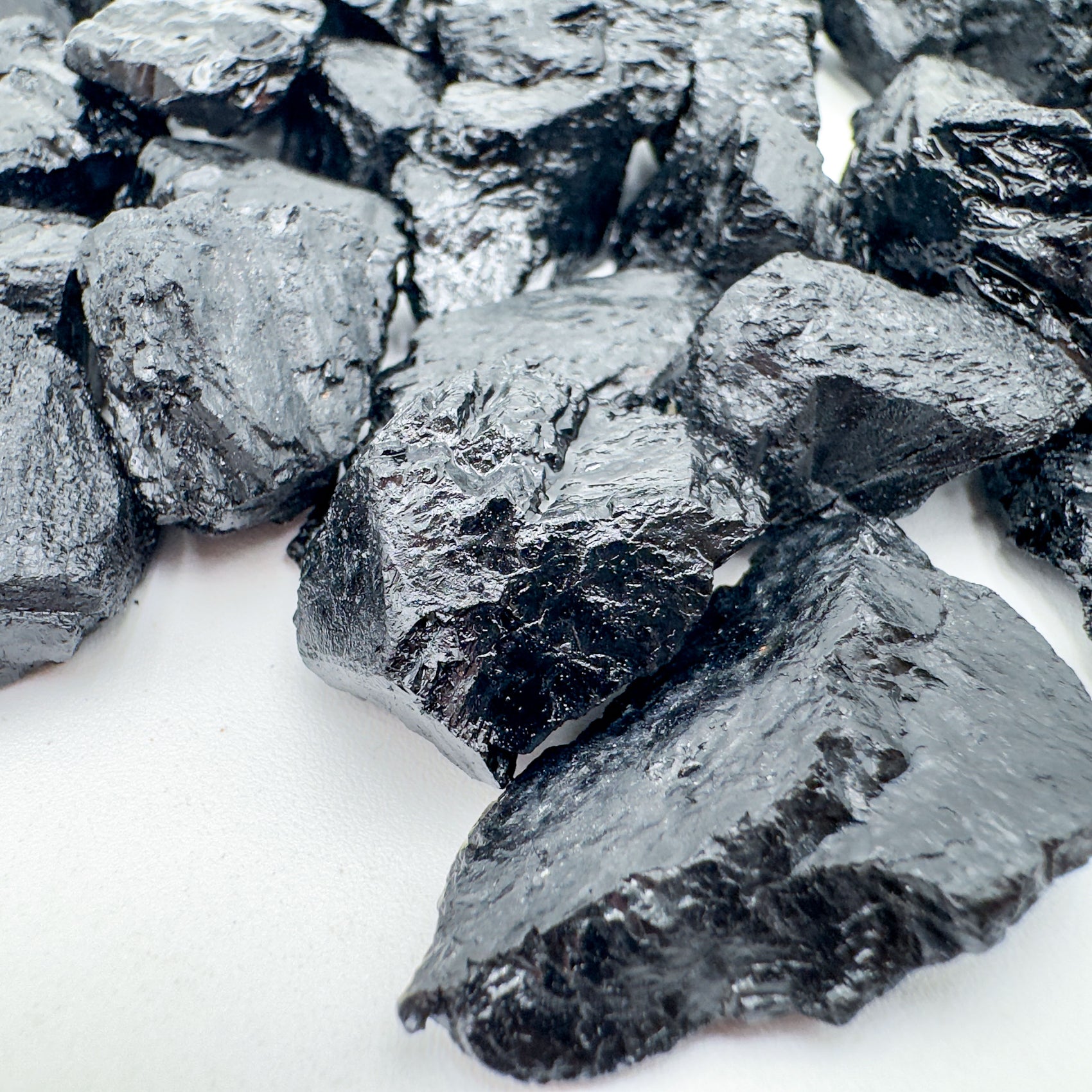 Side profile of Grade A Black Tourmaline raw stone, showing open form.