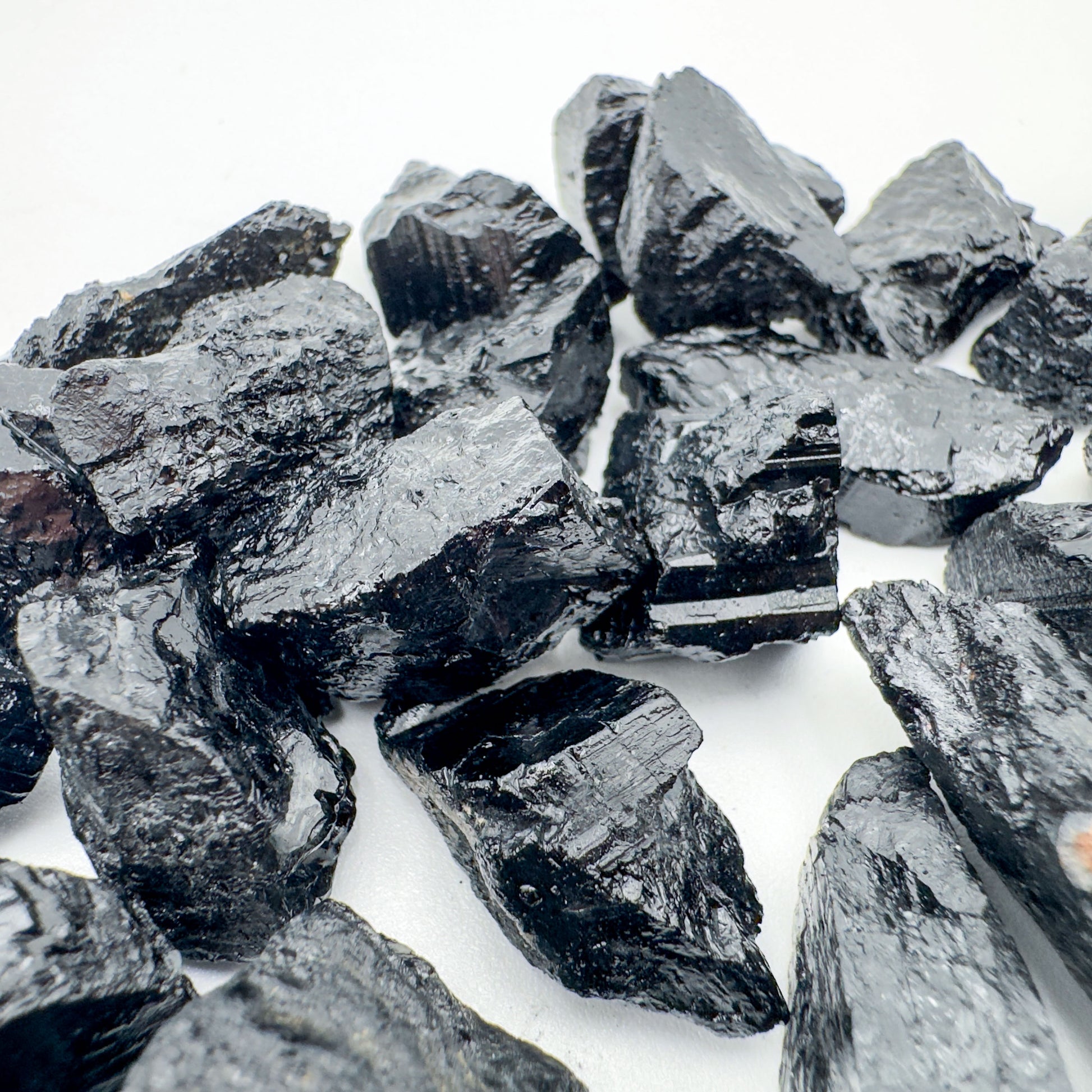 Resting display of Black Tourmaline raw crystal, from Minas Gerais, Brazil, captured in natural daylight.