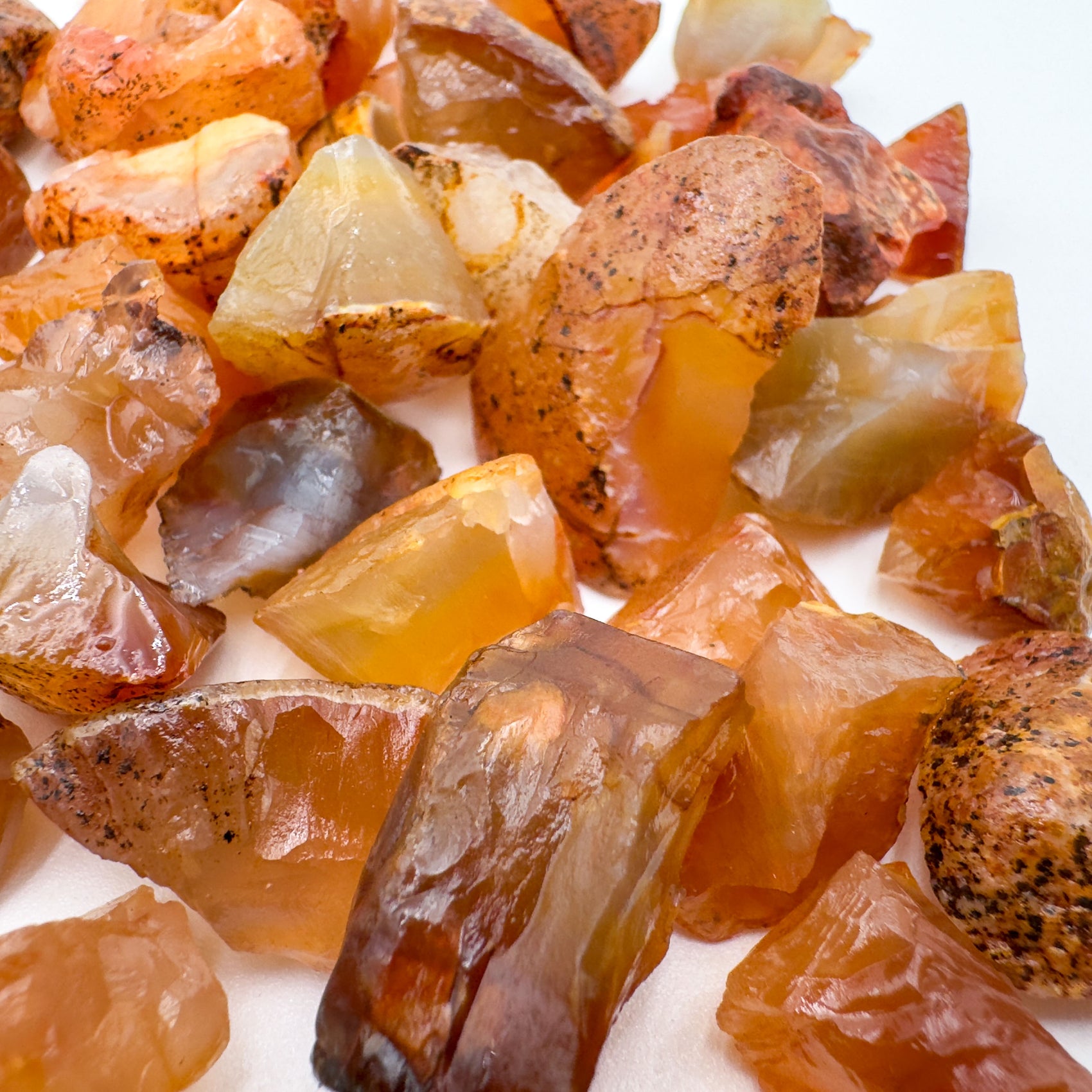 Bottom side of Grade A orange Carnelian raw stone, hand-selected from Rio Grande do Sul, Brazil, showing natural inclusions.