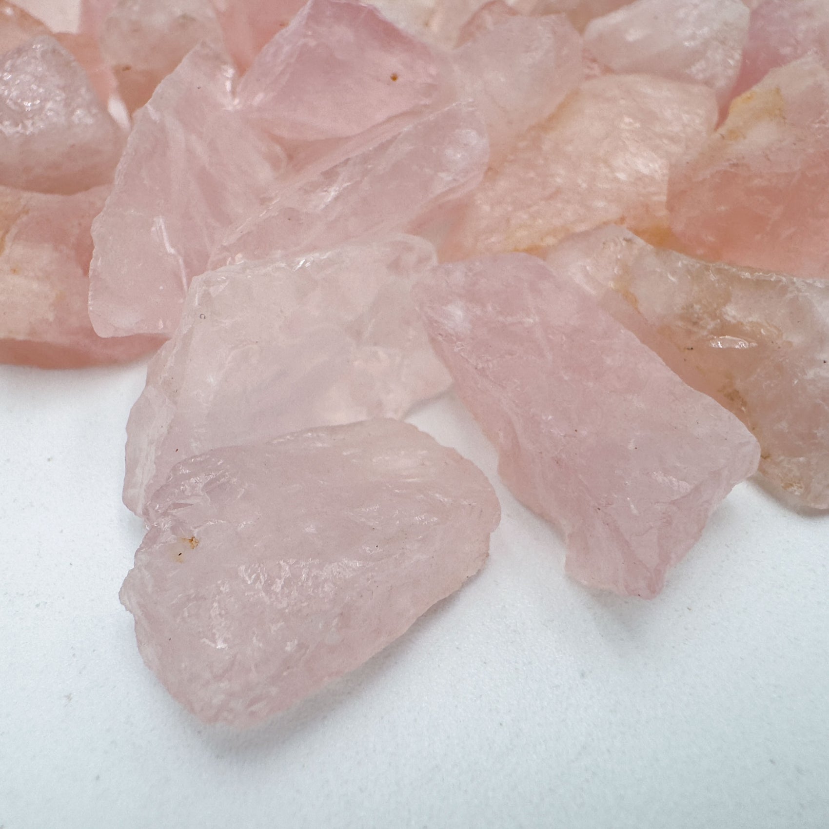 Side profile of Rose Quartz raw stone, sourced from Minas Gerais, Brazil, showing natural color depth.