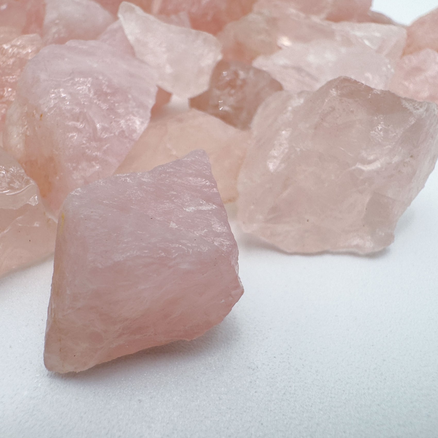 Top-side view of Grade AA Rose Quartz raw stone, showing subtle veining, hand-selected from Minas Gerais, Brazil.