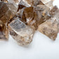 Overhead view of Smoky Quartz raw stone, showing natural banding.