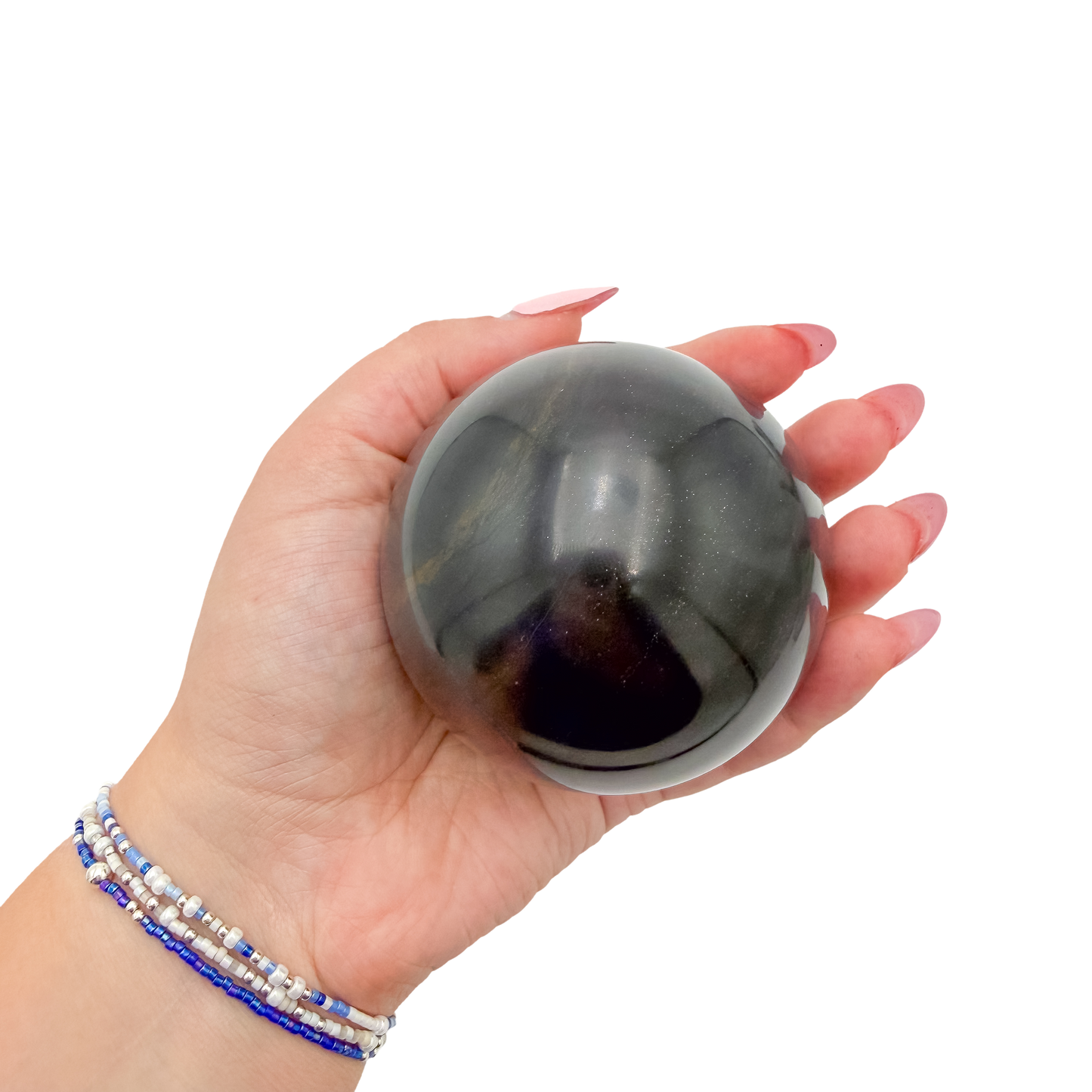 Black Jade sphere no. 1 held in an open hand, showing the true scale of this 2.87 inch, 554 gram orb.