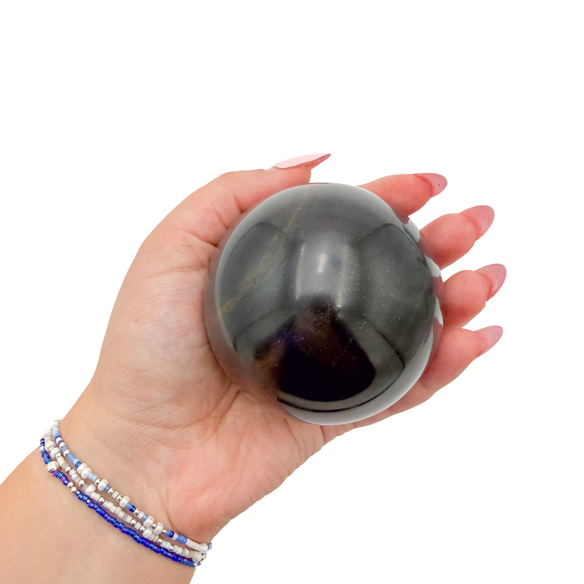 Black Jade sphere no. 1 held in an open hand, showing the true scale of this 2.87 inch, 554 gram orb.