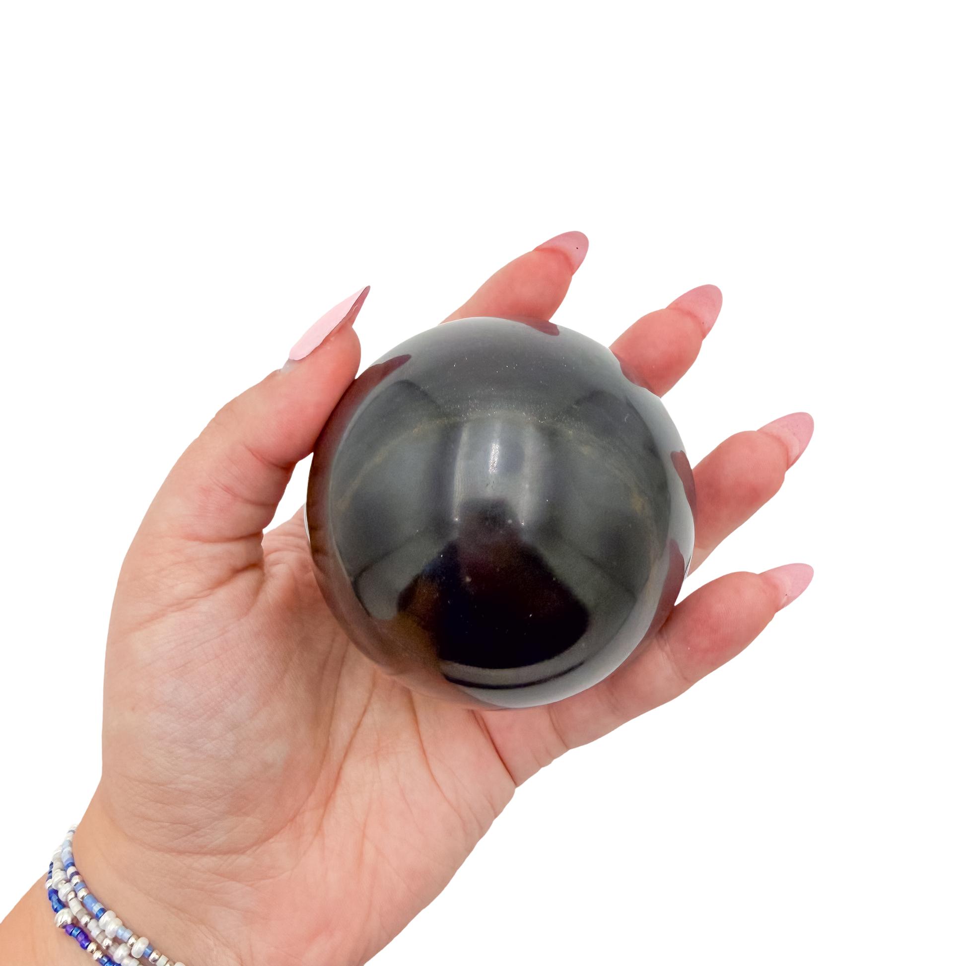 Black Jade sphere no. 4 held in an open hand, showing the true scale of this 2.81 inch, 530 gram orb.