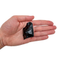 AA Grade Black Obsidian raw stone held in hand for scale, from Argentina