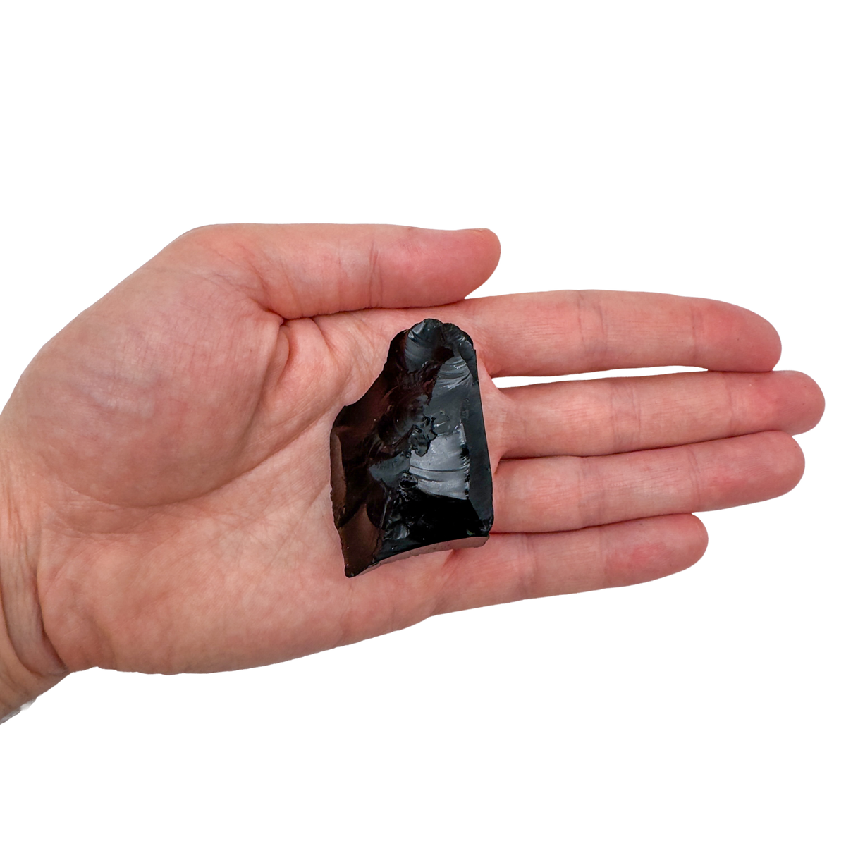 AA Grade Black Obsidian raw stone held in hand for scale, from Argentina