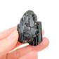 Raw black tourmaline specimen from Madagascar held in hand to show scale