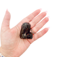 Raw black tourmaline specimen from Madagascar held in hand to show scale