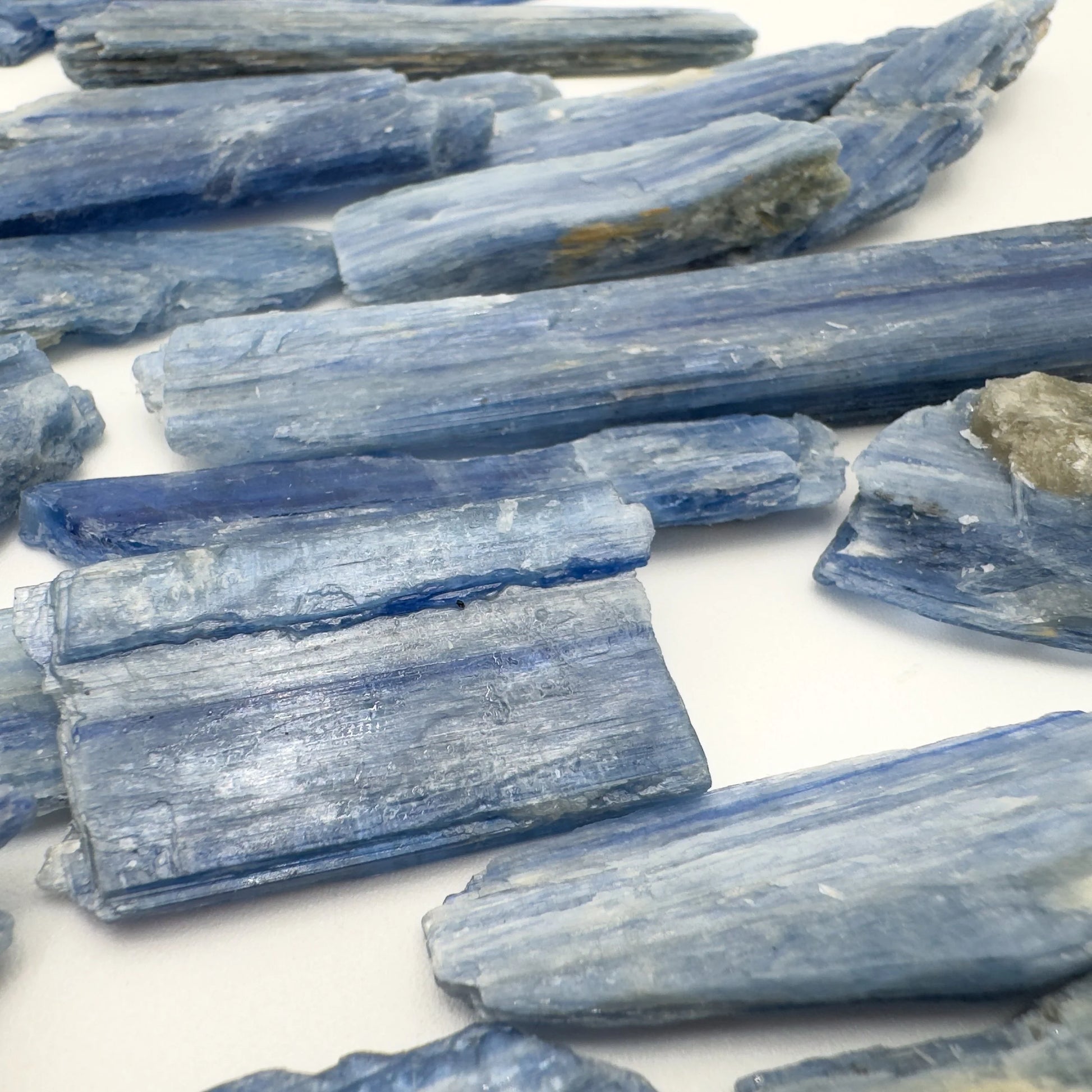 Back view of Blue Kyanite raw stone, showing characteristic patterning, carried for Confidence.