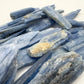 Grade aa blue kyanite raw held in hand for size reference