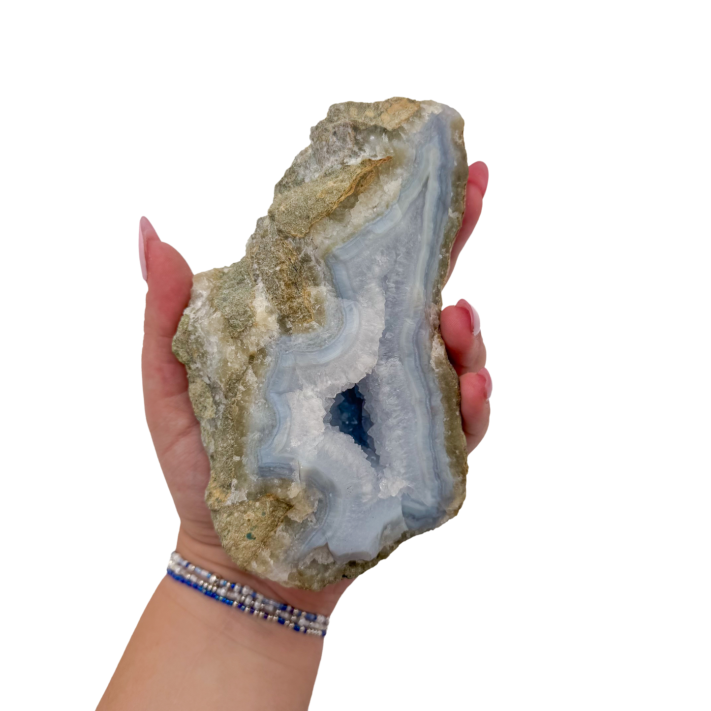 Blue lace agate raw geode held in hand to show scale