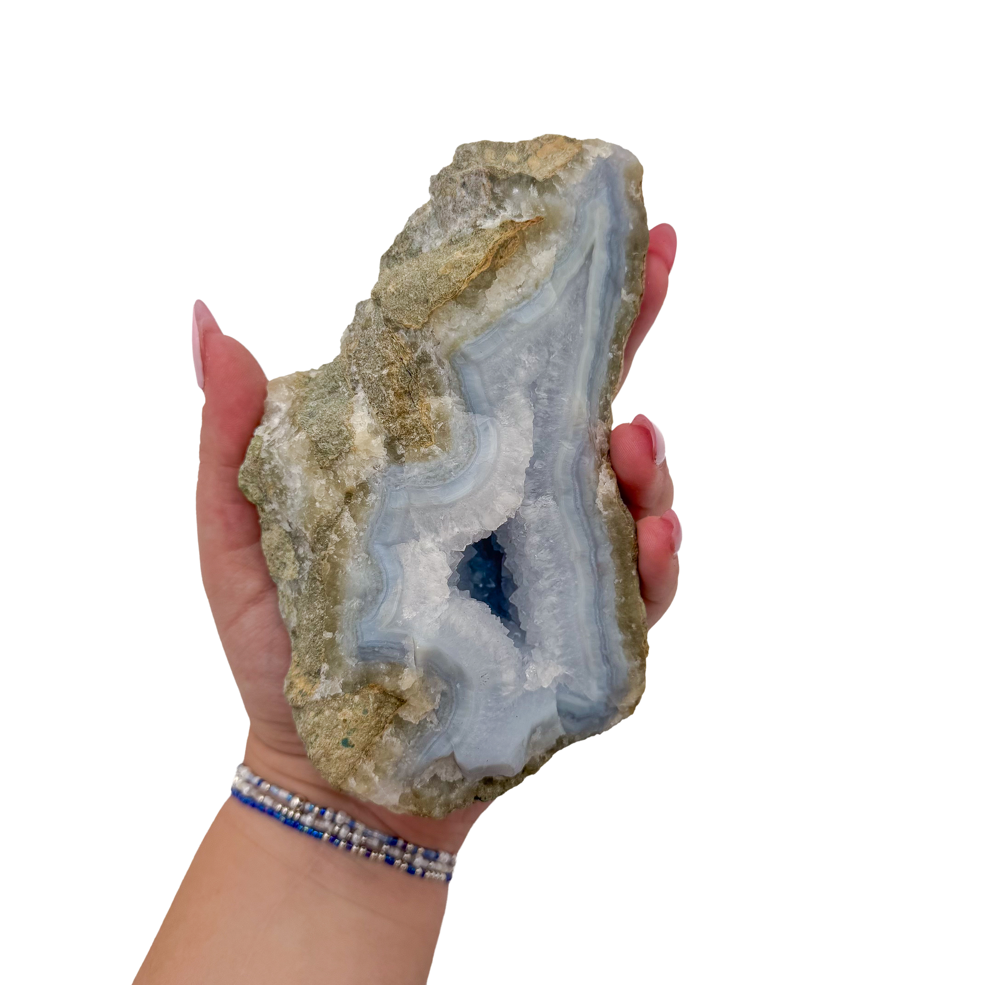 Blue lace agate raw geode held in hand to show scale