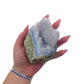Blue lace agate raw geode held in hand to show scale