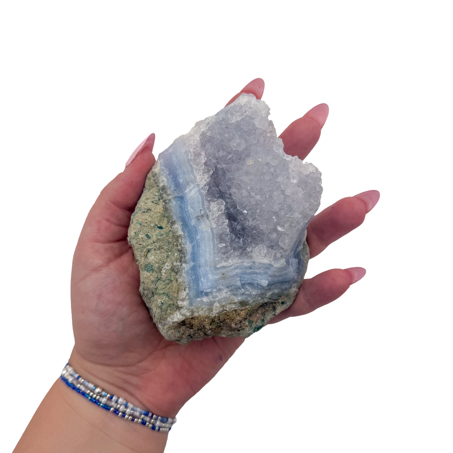 Blue lace agate raw geode held in hand to show scale