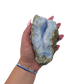 Blue lace agate raw geode held in hand to show scale