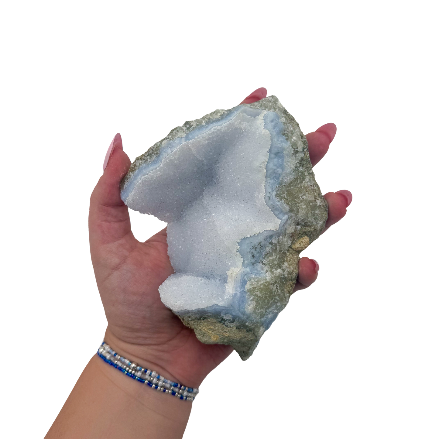 Blue lace agate raw geode held in hand to show scale