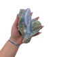 Blue lace agate raw geode held in hand to show scale