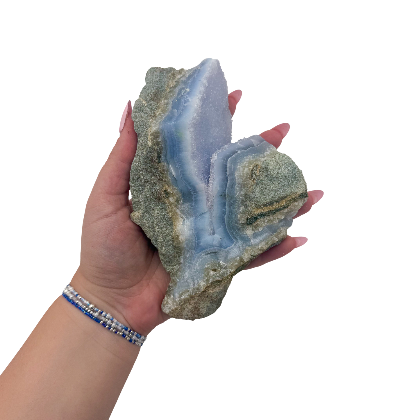 Blue lace agate raw geode held in hand to show scale