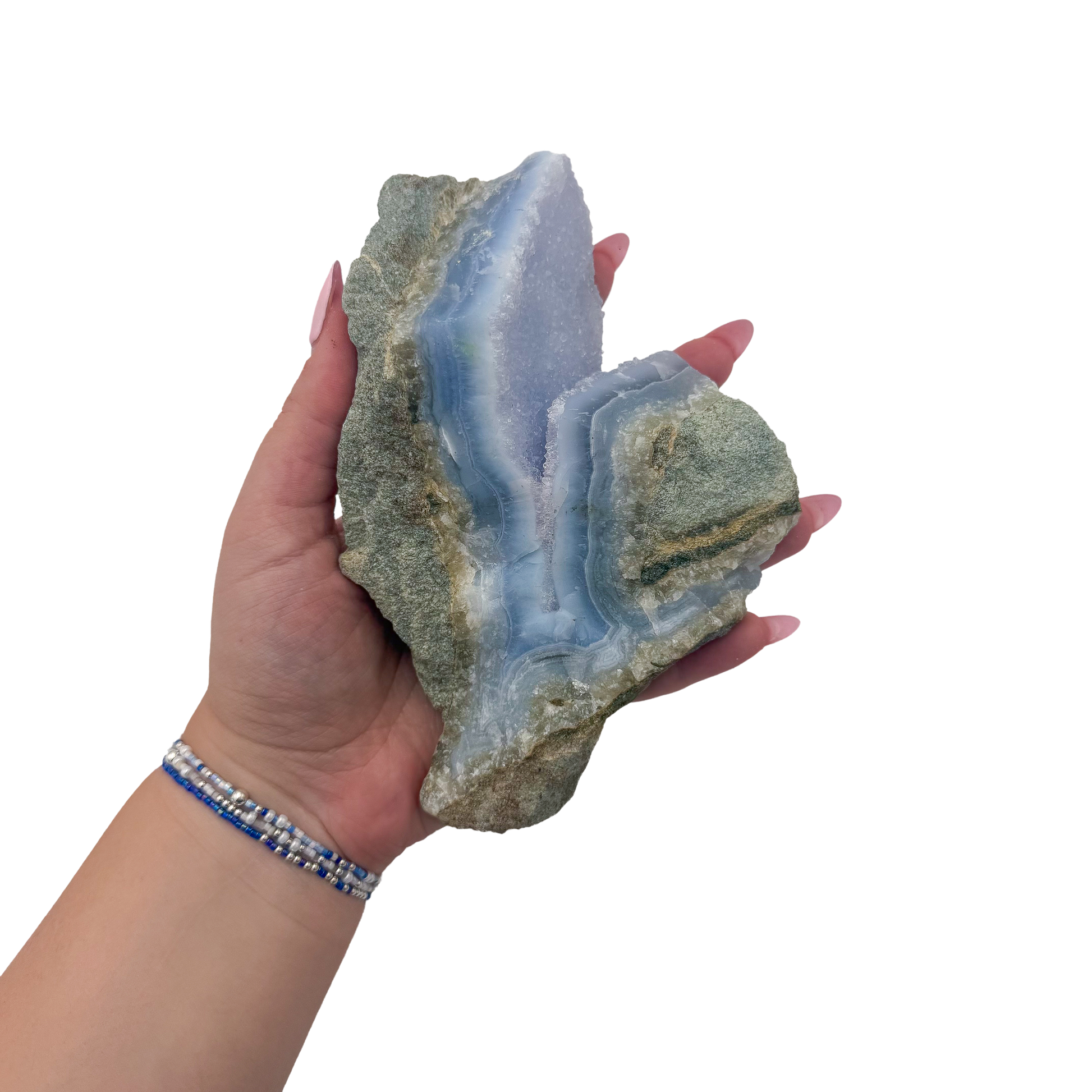 Blue lace agate raw geode held in hand to show scale