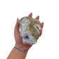 Blue lace agate raw geode held in hand to show scale