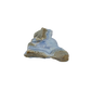 Blue lace agate raw geode, long banded face angled into the light