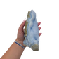 Blue lace agate raw geode held in hand to show scale