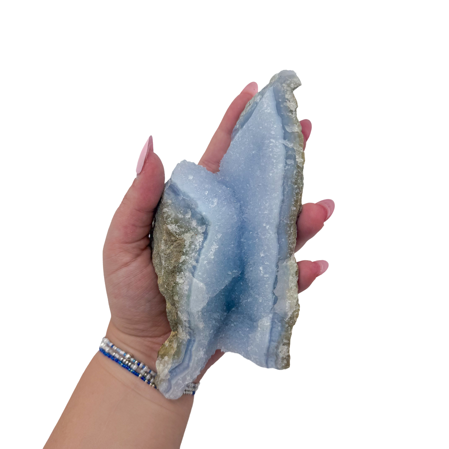 Blue lace agate raw geode held in hand to show scale