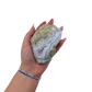 Blue lace agate raw geode held in hand to show scale
