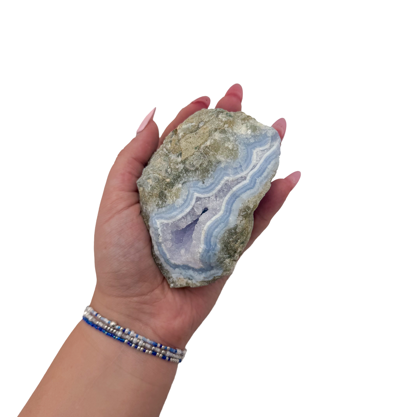 Blue lace agate raw geode held in hand to show scale