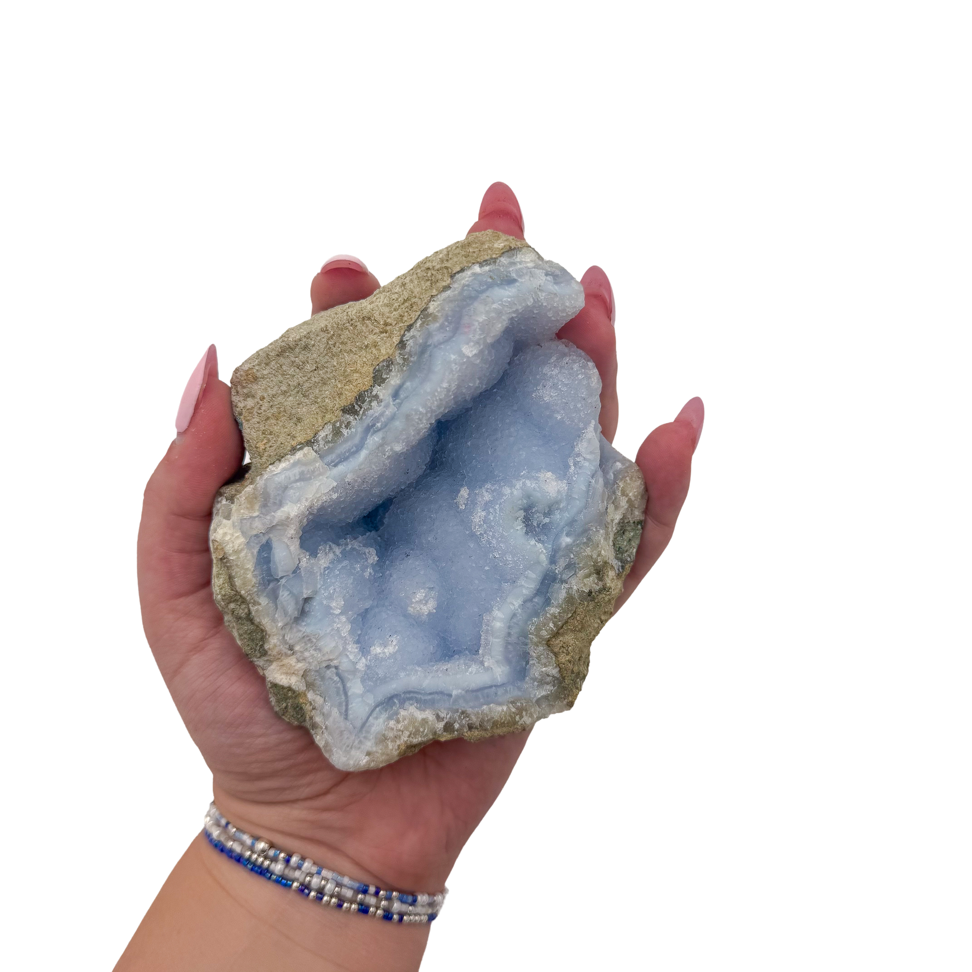 Blue lace agate raw geode held in hand to show scale