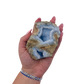Blue lace agate raw geode held in hand to show scale
