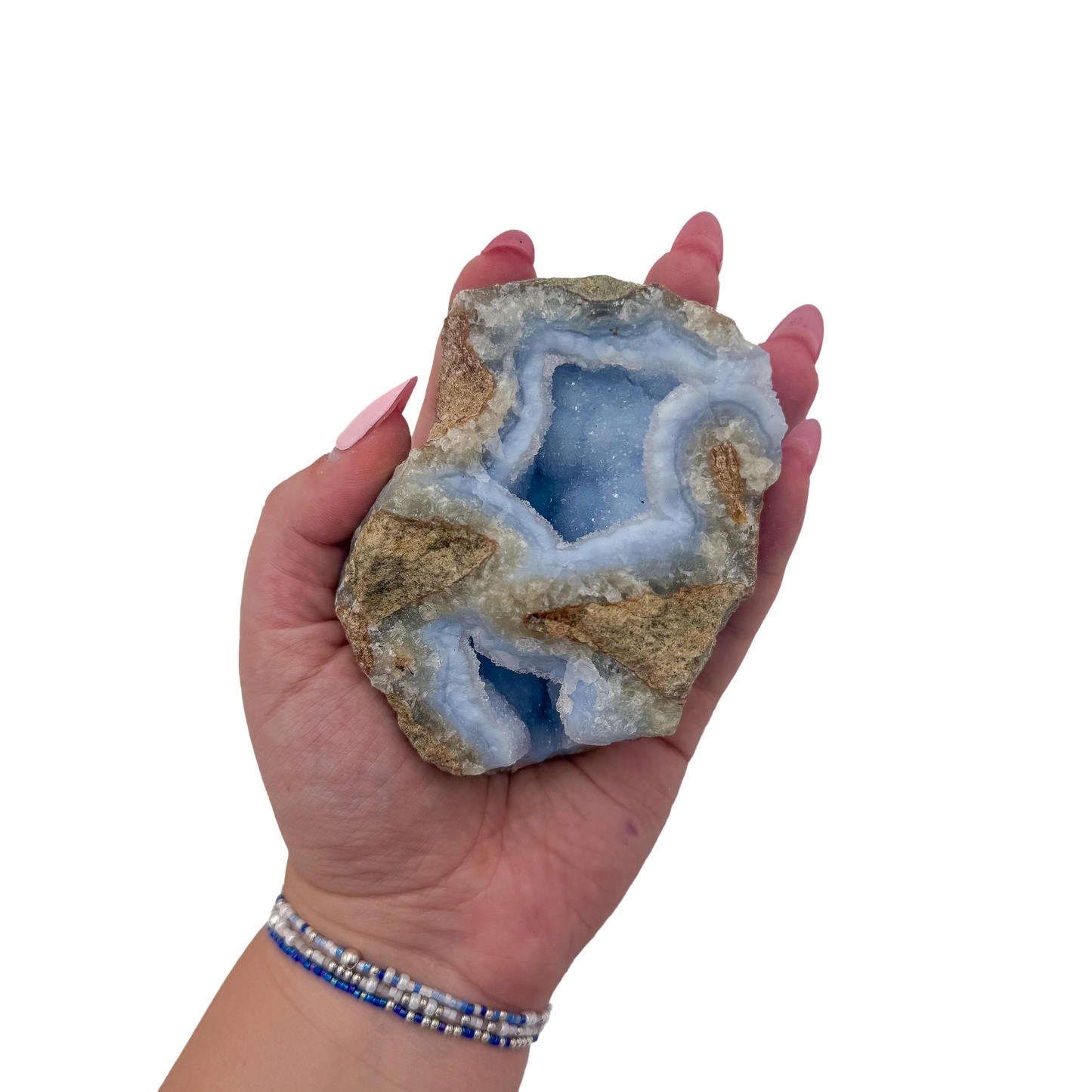 Blue lace agate raw geode held in hand to show scale
