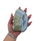 Blue lace agate raw geode held in hand to show scale