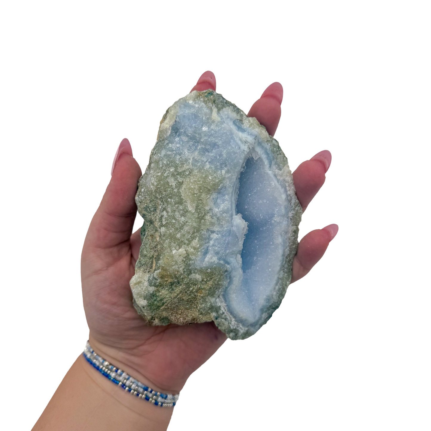 Blue lace agate raw geode held in hand to show scale