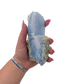 Blue lace agate raw geode held in hand to show scale
