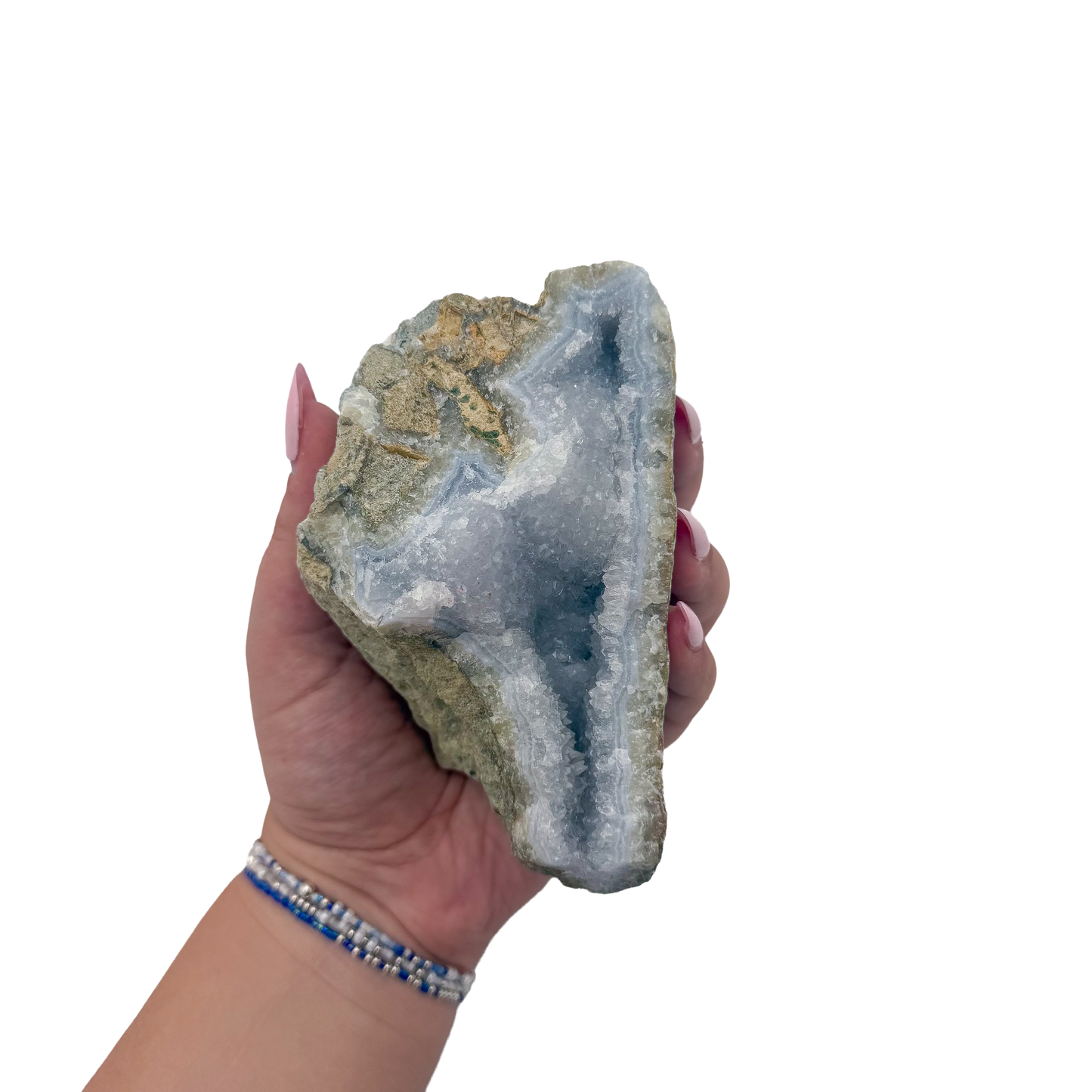 Blue lace agate raw geode held in hand to show scale