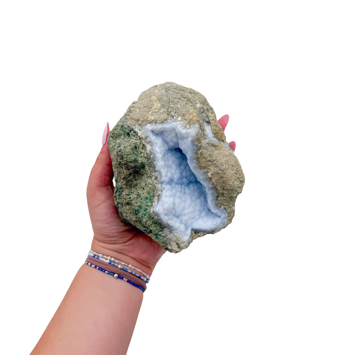 Blue lace agate raw geode held in hand to show scale