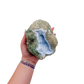 Blue lace agate raw geode held in hand to show scale