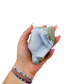 Blue lace agate raw geode held in hand to show scale