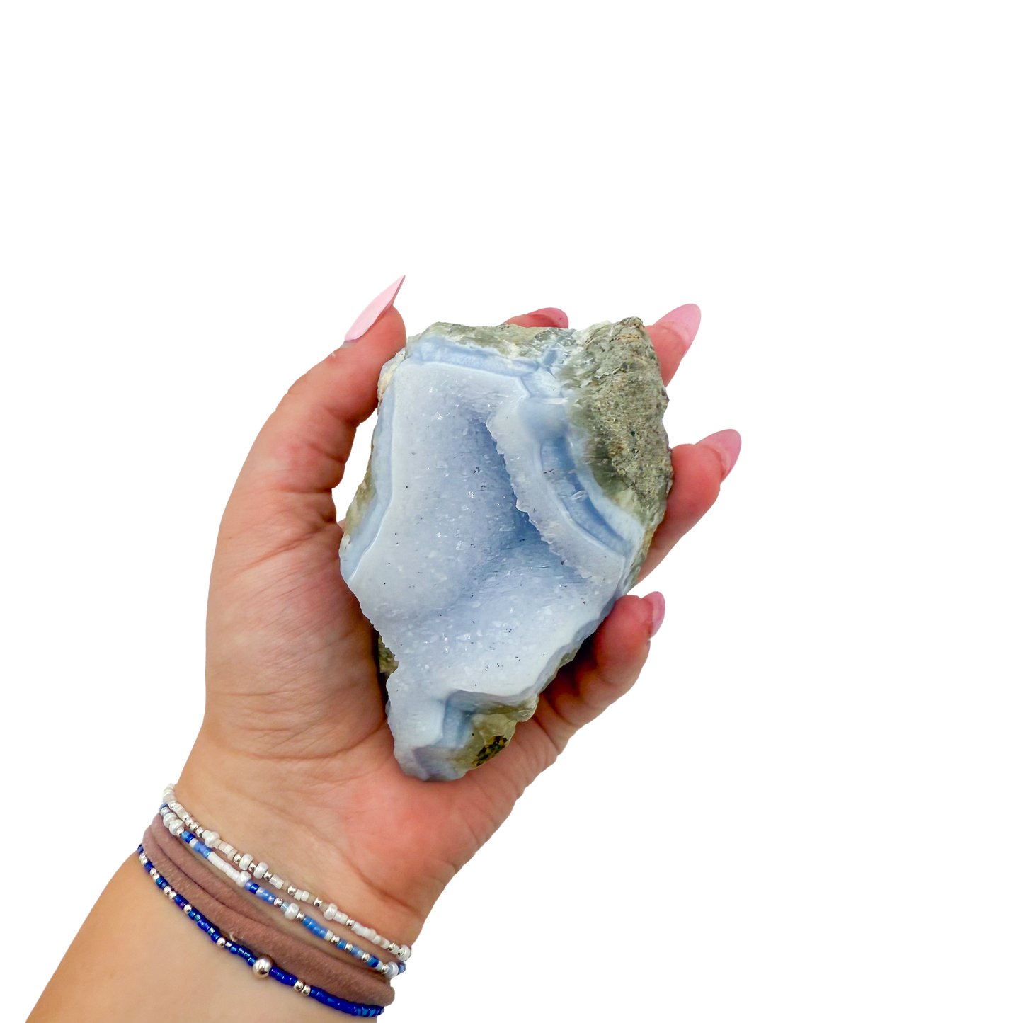 Blue lace agate raw geode held in hand to show scale