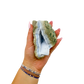 Blue lace agate raw geode held in hand to show scale