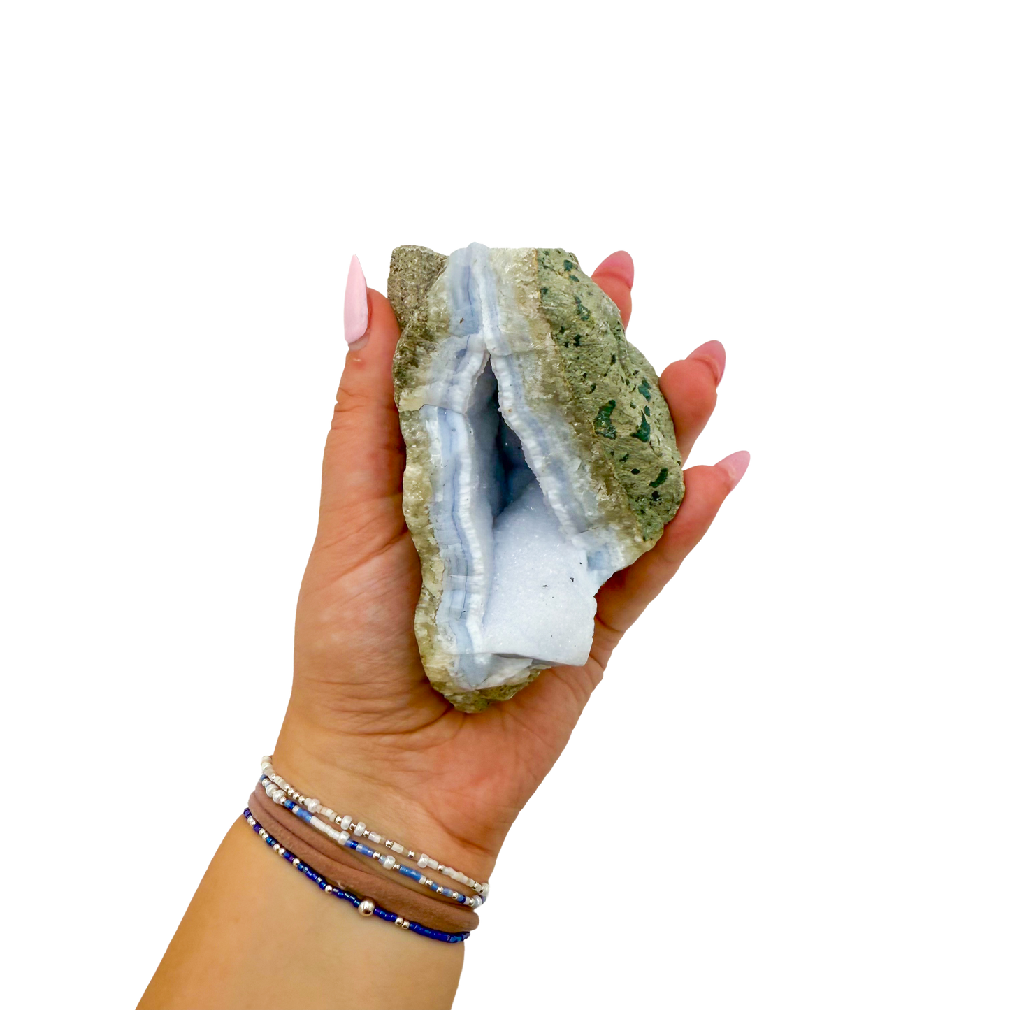 Blue lace agate raw geode held in hand to show scale